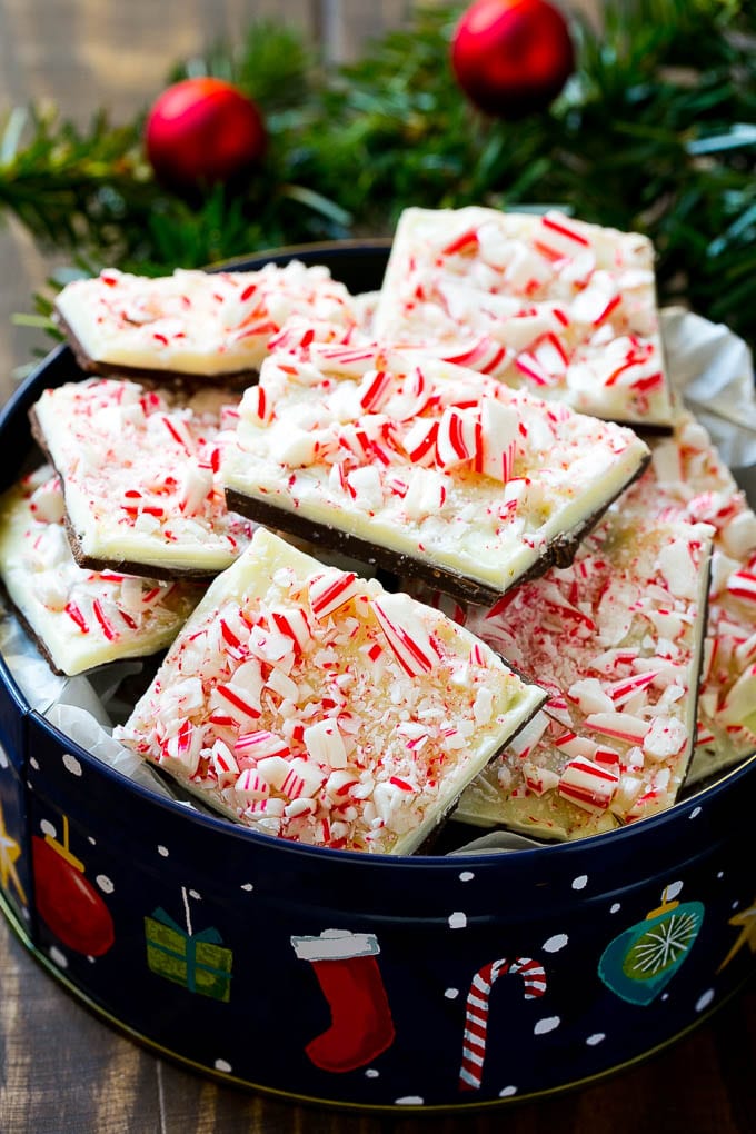 A gift tin full of peppermint bark made with crushed candy canes.