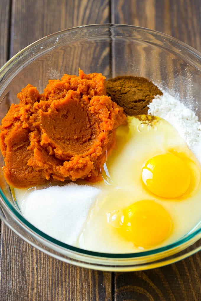 Sugar, eggs, pumpkin puree, flour and spices in a mixing bowl.