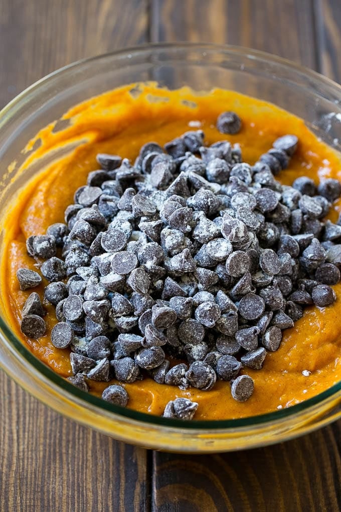 Pumpkin bread batter with chocolate chips in it.