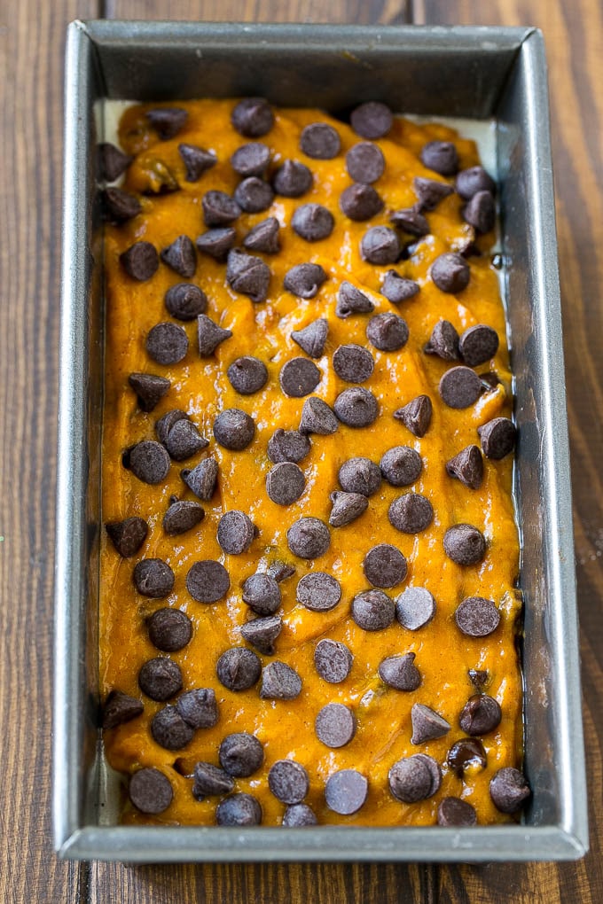 A loaf pan of pumpkin chocolate chip bread batter.