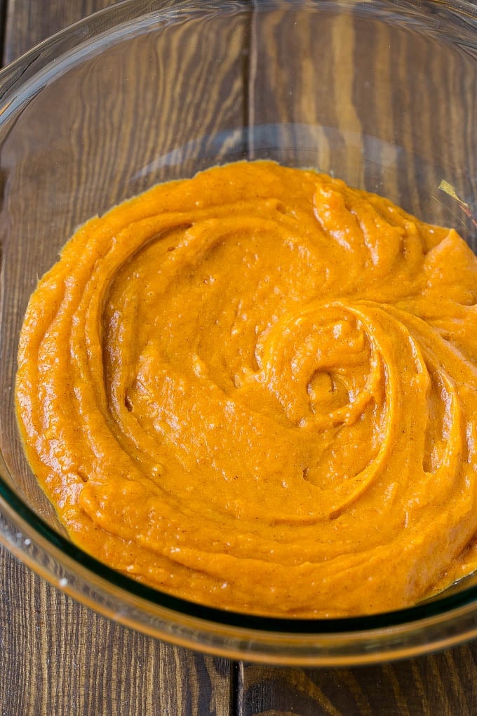 A bowl full of pumpkin chocolate chip muffin batter.