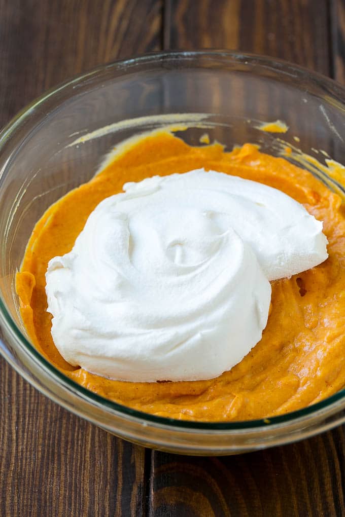 Cool whip in a bowl with the base of pumpkin dip.