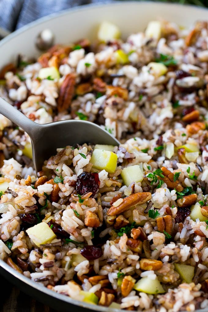 A skillet of rice pilaf with apples, cranberries and pecans.