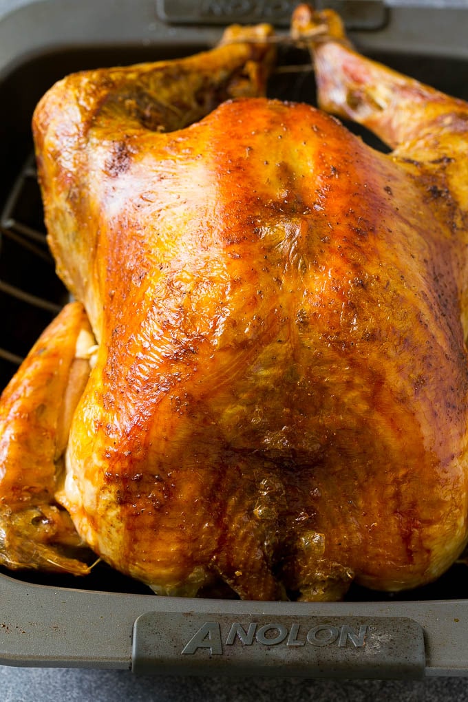 A roasted turkey in a baking pan.