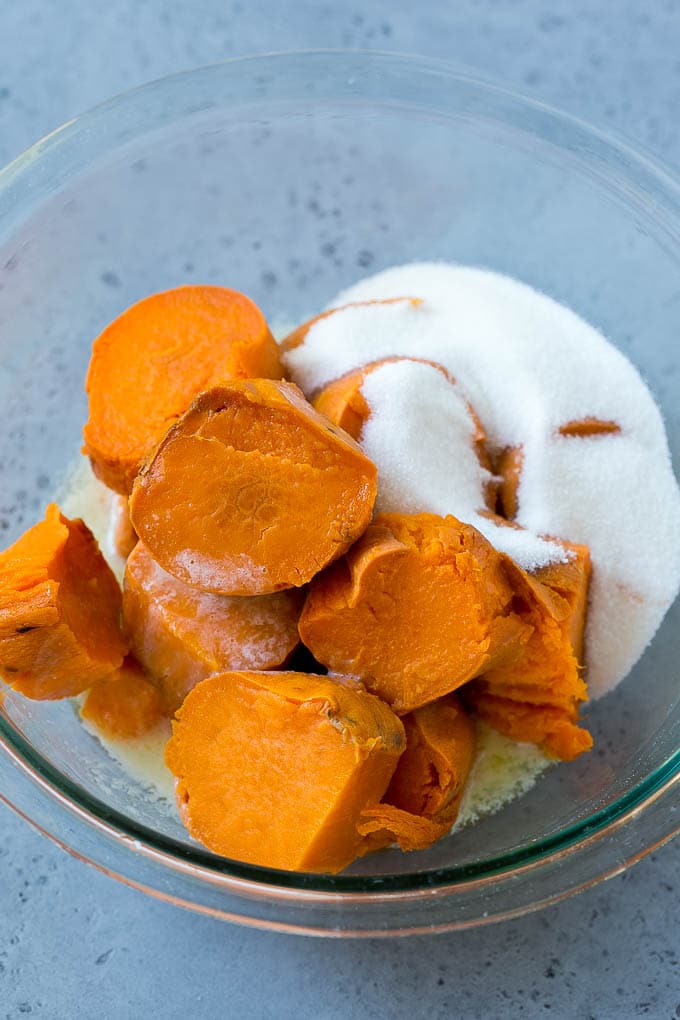 Sweet potatoes, sugar and butter in a bowl.