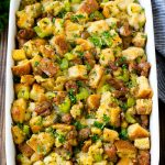 A baking dish of sausage stuffing made with Italian sausage, bread cubes and vegetables.
