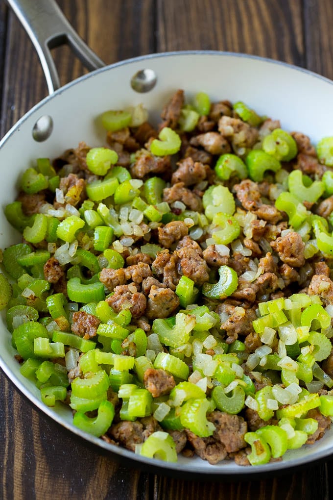 A pan of cooked sausage, celery and onions.