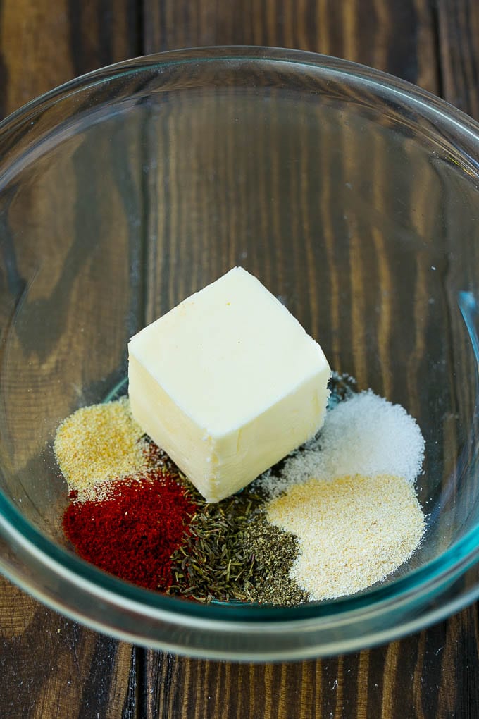 Butter and seasonings in a mixing bowl.