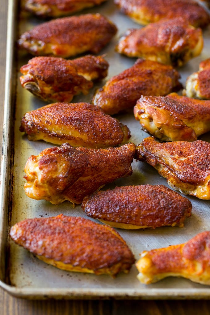 Smoked chicken wings coated in spice rub on a sheet pan.