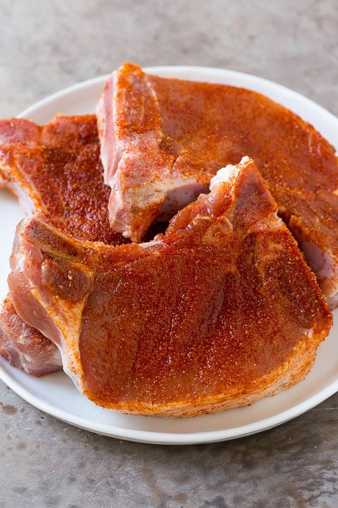 Pork chops coated in olive oil and BBQ spice rub.