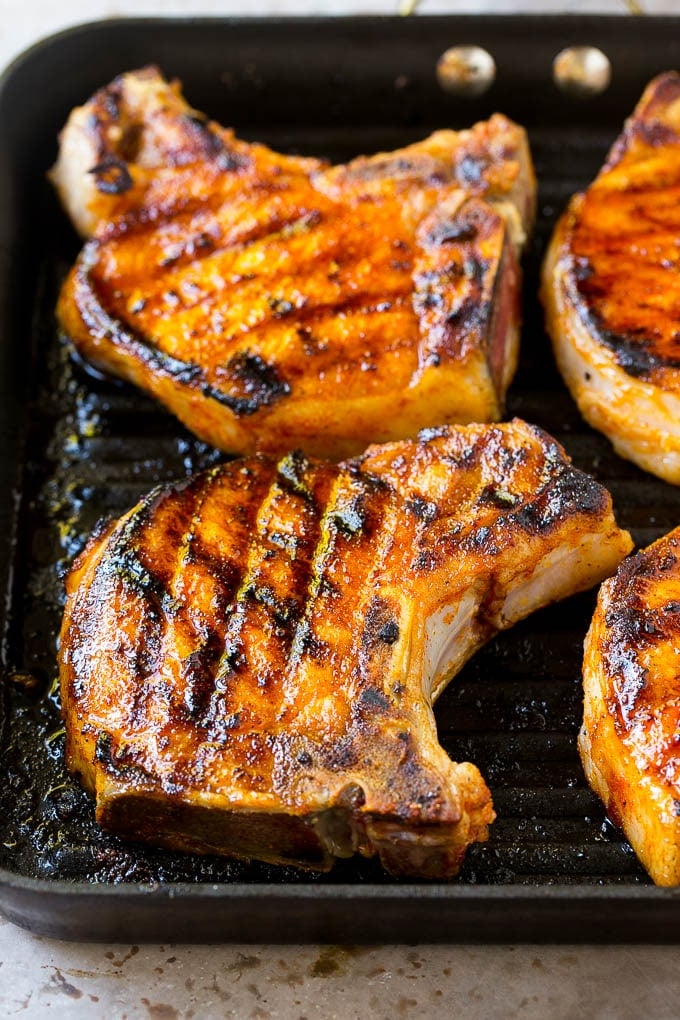 Seared pork chops in a grill pan.