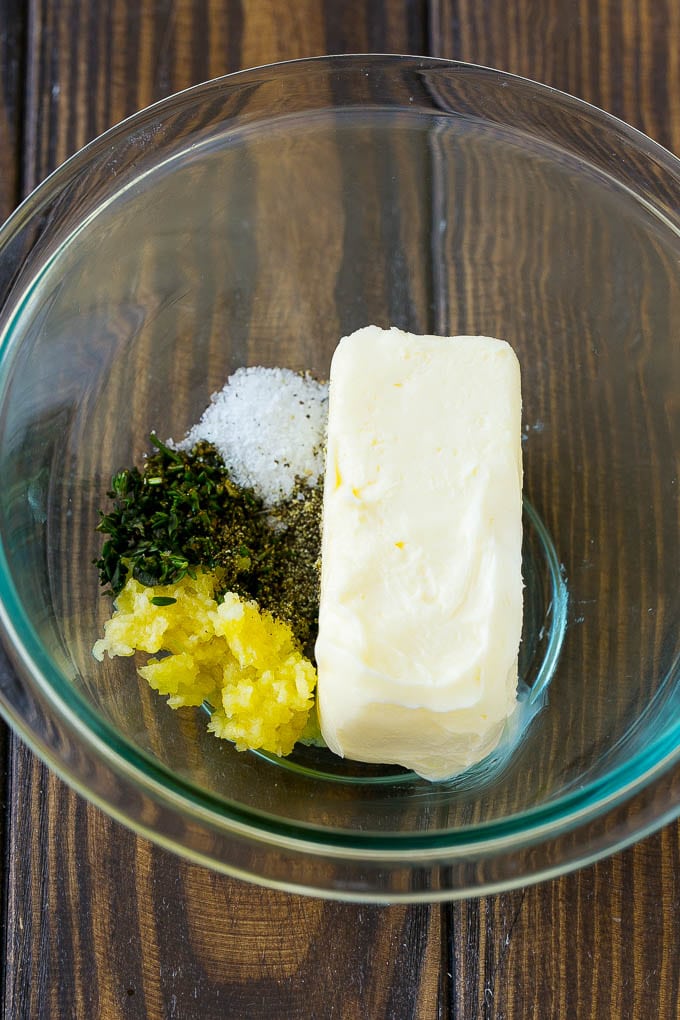 Butter, garlic and herbs in a mixing bowl.