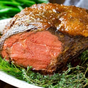 A smoked prime rib roast cooked to medium rare on a serving platter.