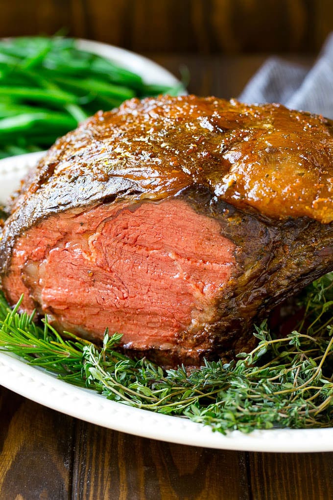 A smoked prime rib roast cooked to medium rare on a serving platter.