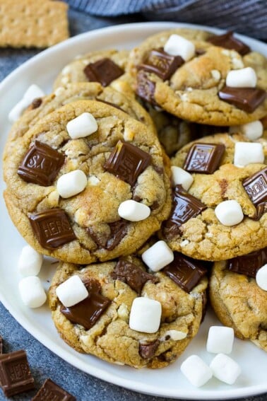 A plate of S'mores cookies topped with milk chocolate bars and marshmallows.