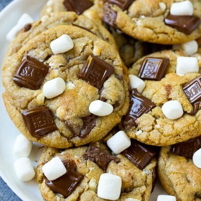 A plate of S'mores cookies topped with milk chocolate bars and marshmallows.