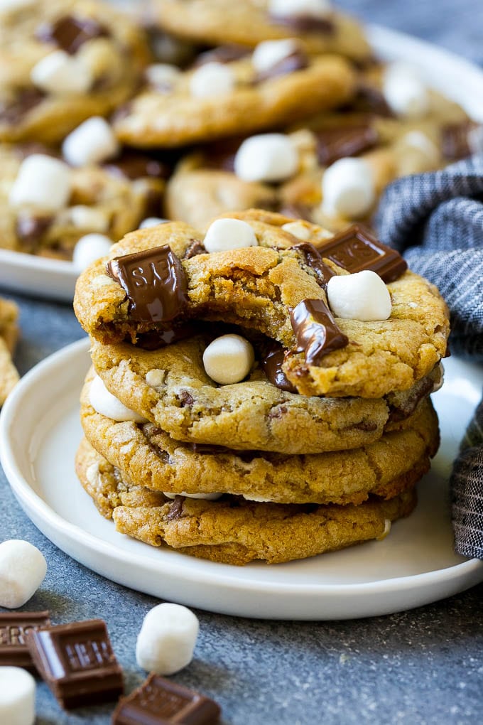A stack of S'mores cookies with a bite taken out of one.