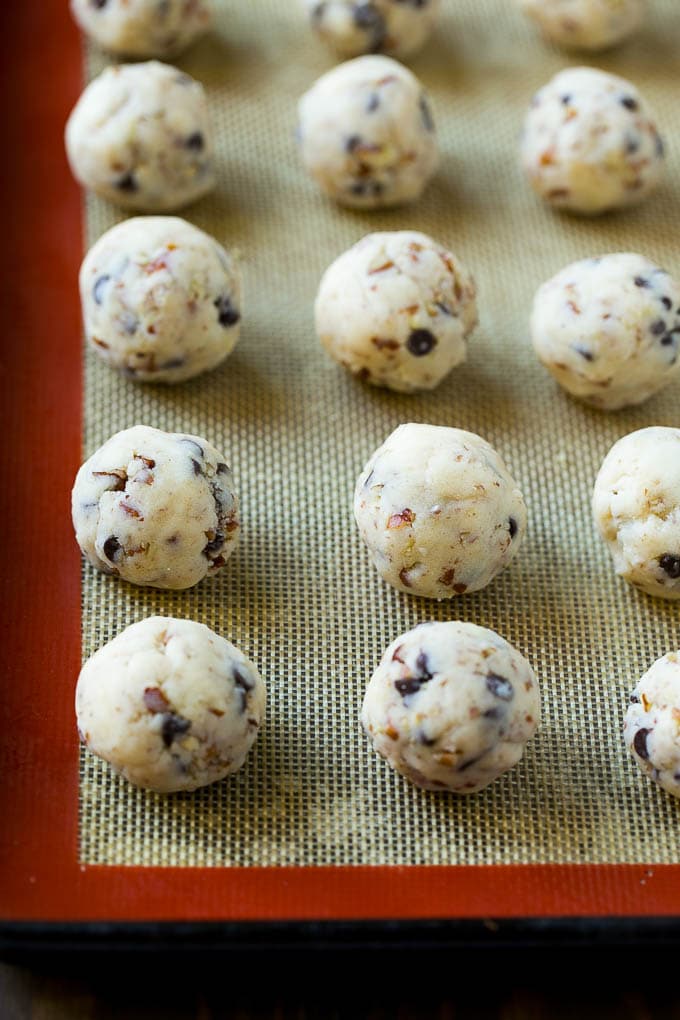 Balls of snowball cookie dough ready to be baked.
