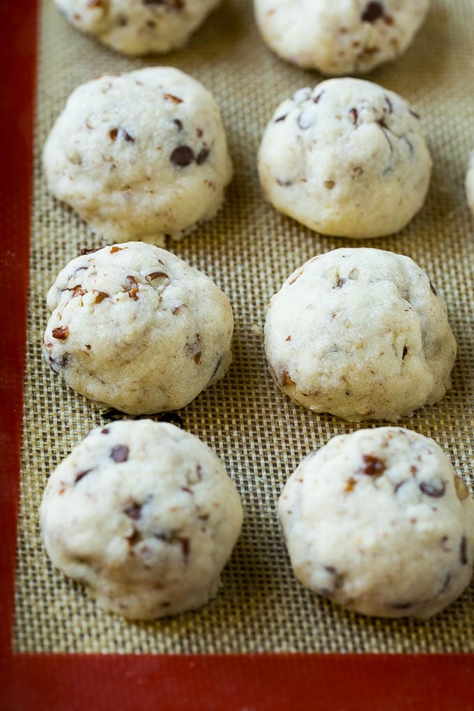 Baked snowball cookies on a sheet pan.