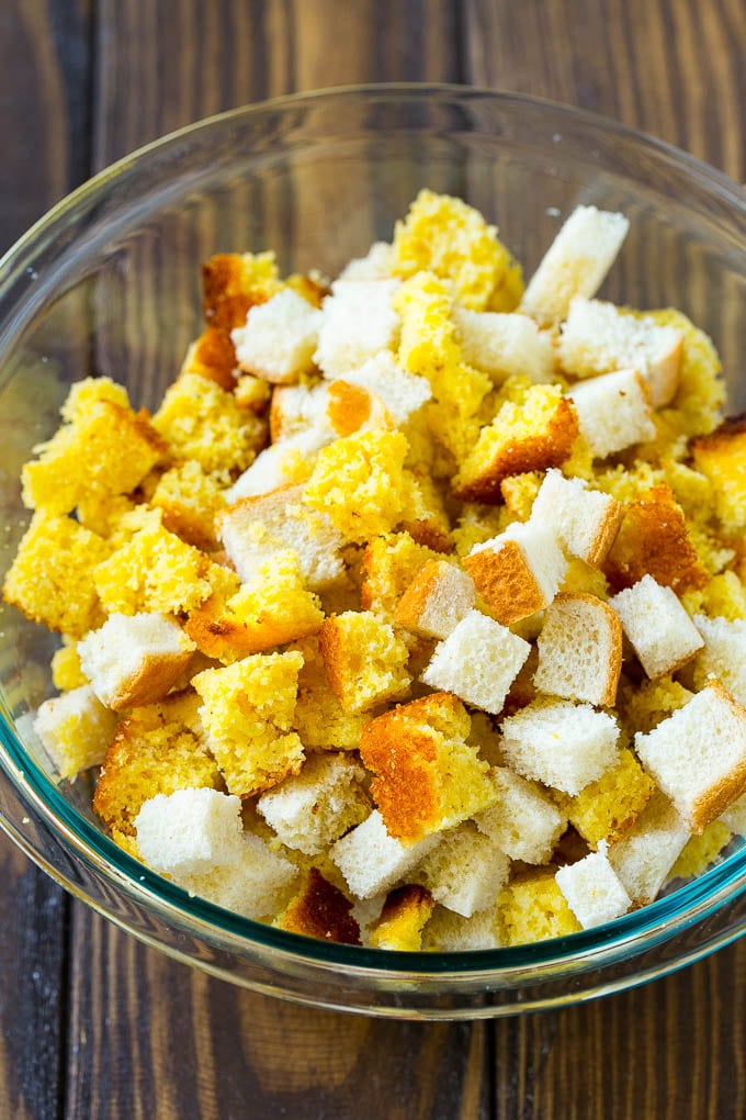 Cornbread and white bread cubes in a mixing bowl.