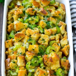 Baked turkey stuffing in a dish topped with fresh parsley.