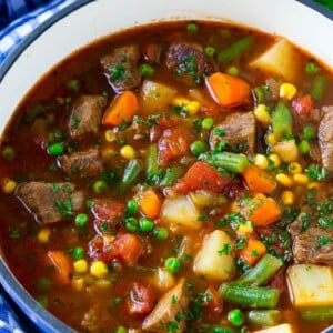 Vegetable beef soup made with chunks of beef, carrots, potatoes, green beans, corn and peas.