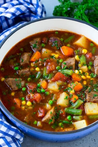 Vegetable beef soup made with chunks of beef, carrots, potatoes, green beans, corn and peas.