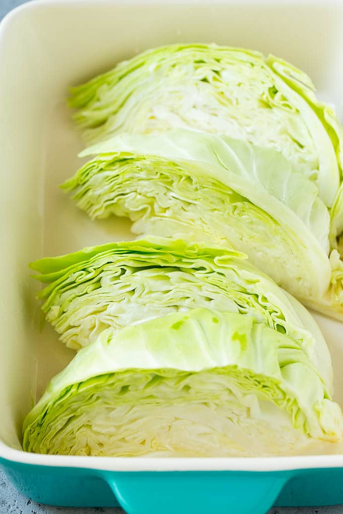 Wedges of cabbage in a baking dish.