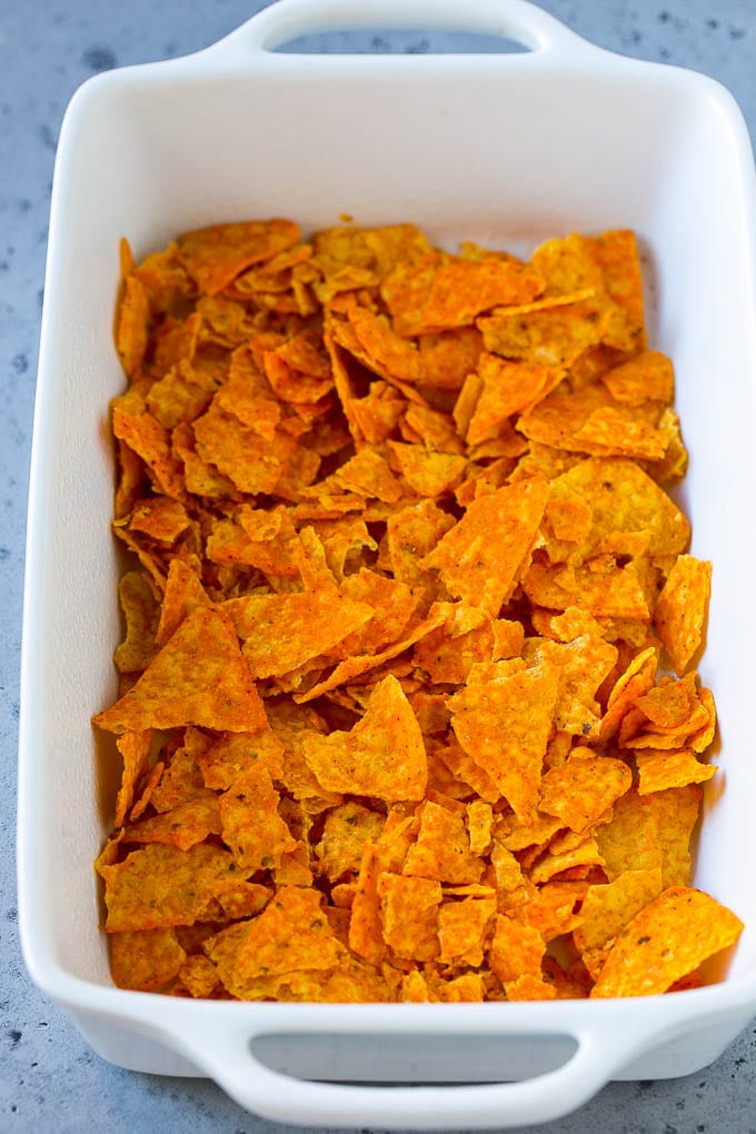Crushed Dorito chips in the bottom of a casserole dish.