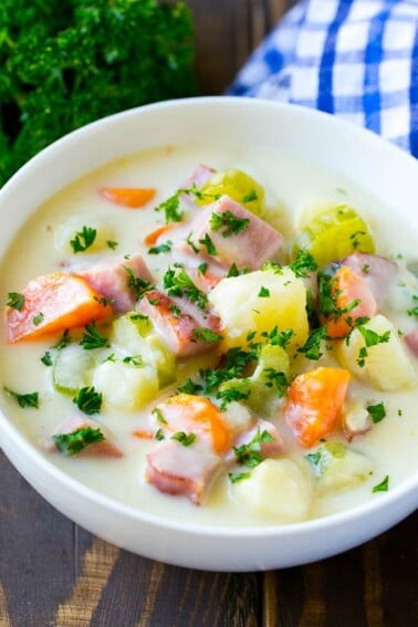 A bowl of ham and potato soup loaded with veggies in a creamy broth.