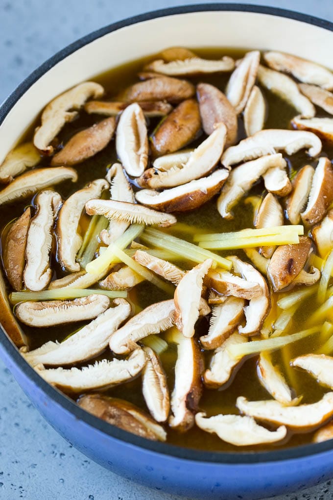 Sliced shiitake mushrooms and bamboo shoots in broth.