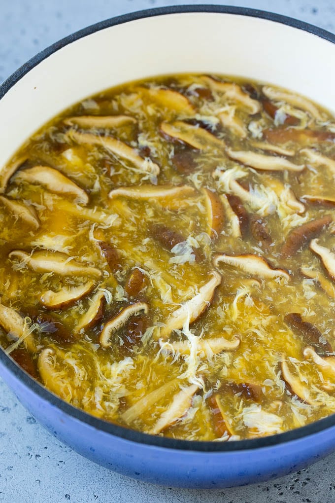 Mushrooms, egg strands and bamboo shoots in broth for hot and sour soup.