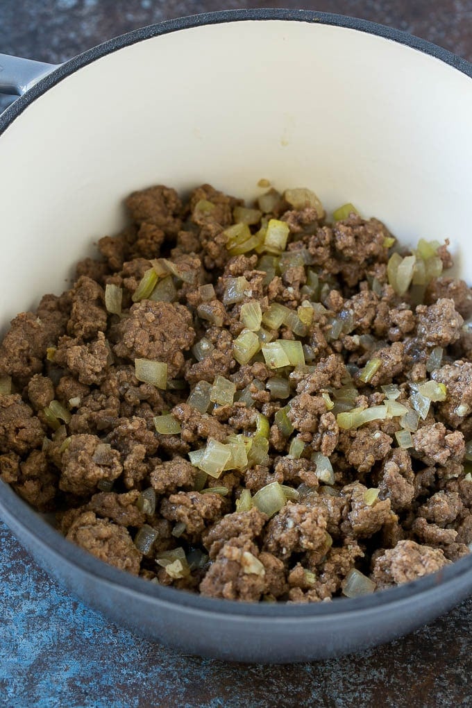 Ground beef and onions in a soup pot.