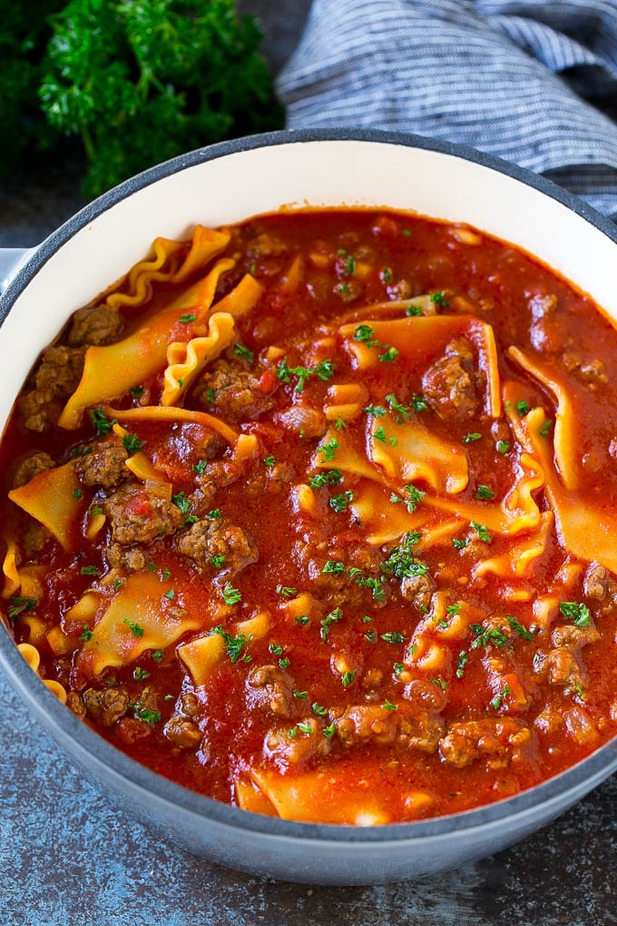 Lasagna soup with ground beef, noodles and tomatoes in broth.