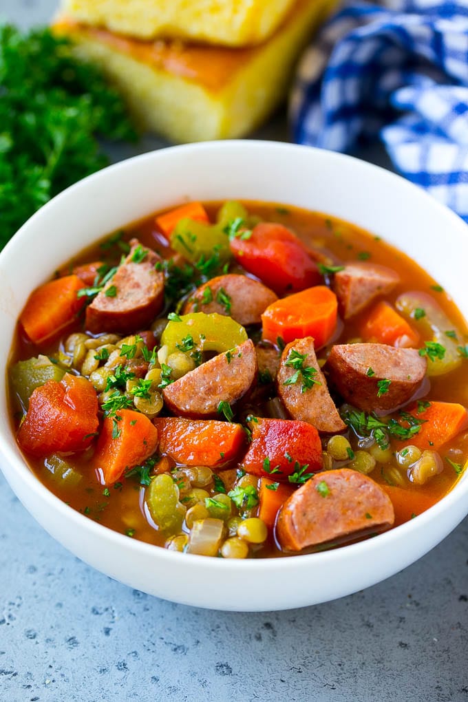 A bowl of lentil soup made with smoked sausage and vegetables.