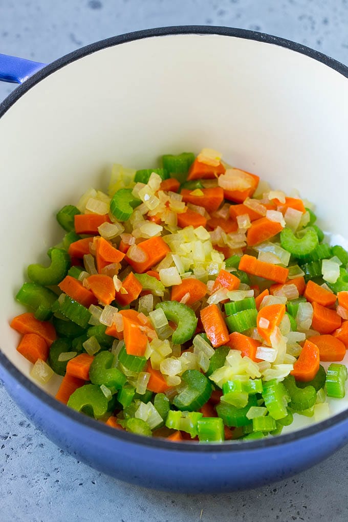 Sauteed carrots, onions and celery in a soup pot.