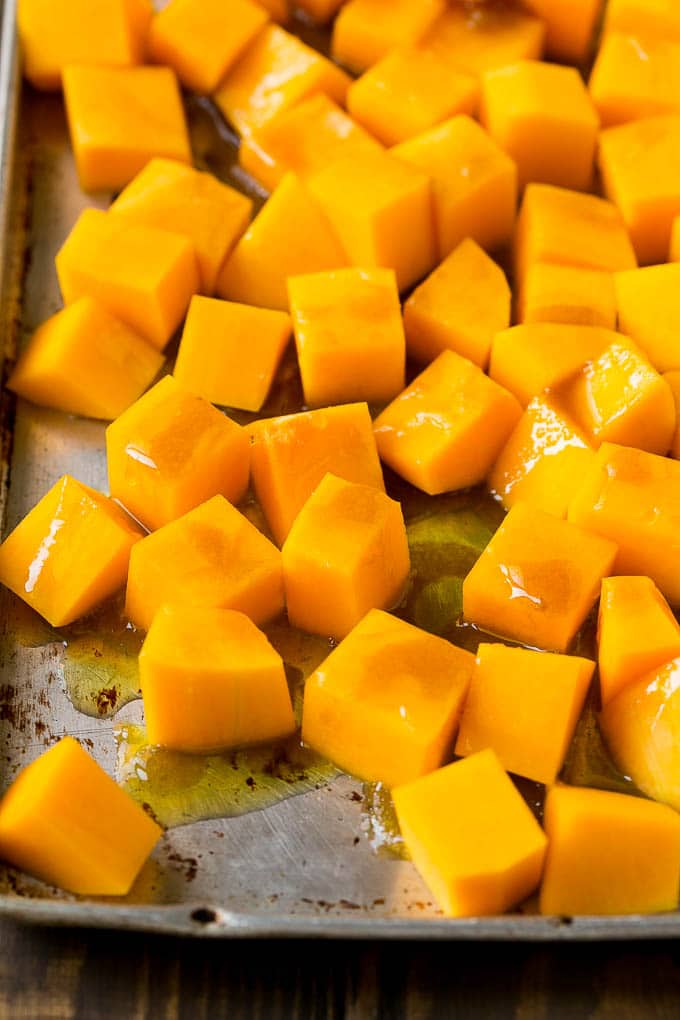 Cubes of winter squash coated in olive oil, brown sugar and maple syrup.