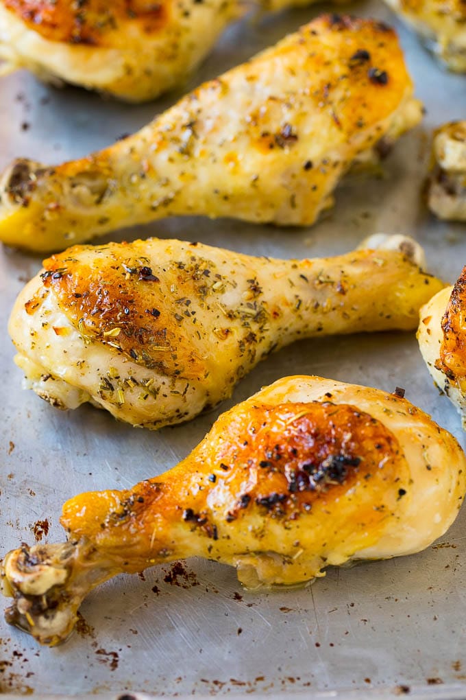 Baked chicken drumsticks on a sheet pan.