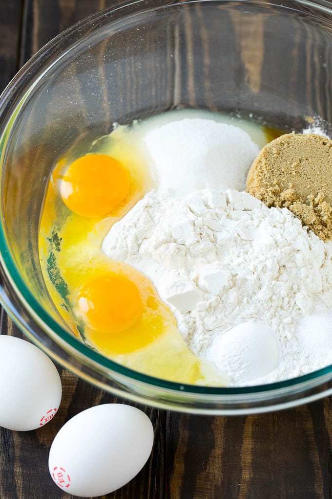 Flour, sugar, baking powder and eggs in a mixing bowl.