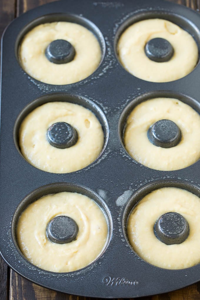 A donut pan filled with dough.