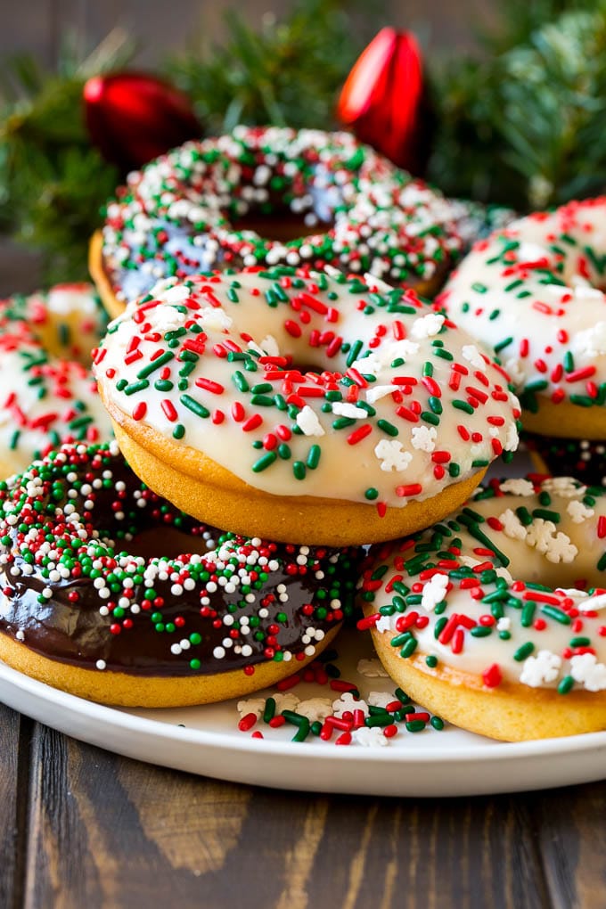 Baked donuts topped with chocolate ganache and decorated with holiday sprinkles.