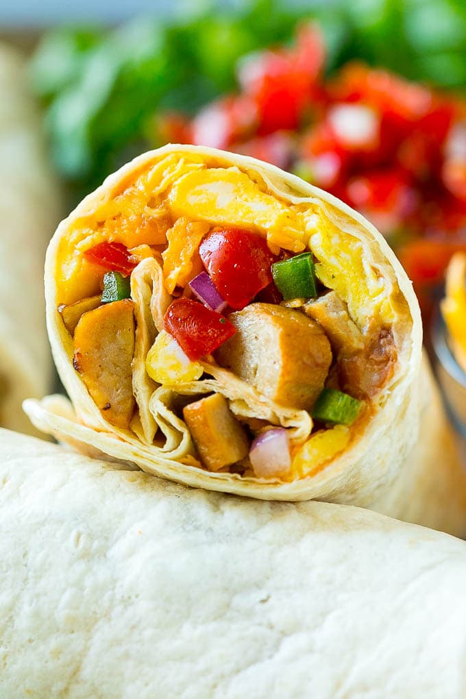 A breakfast burrito stuffed with sausage, eggs, pico de gallo and cheese.