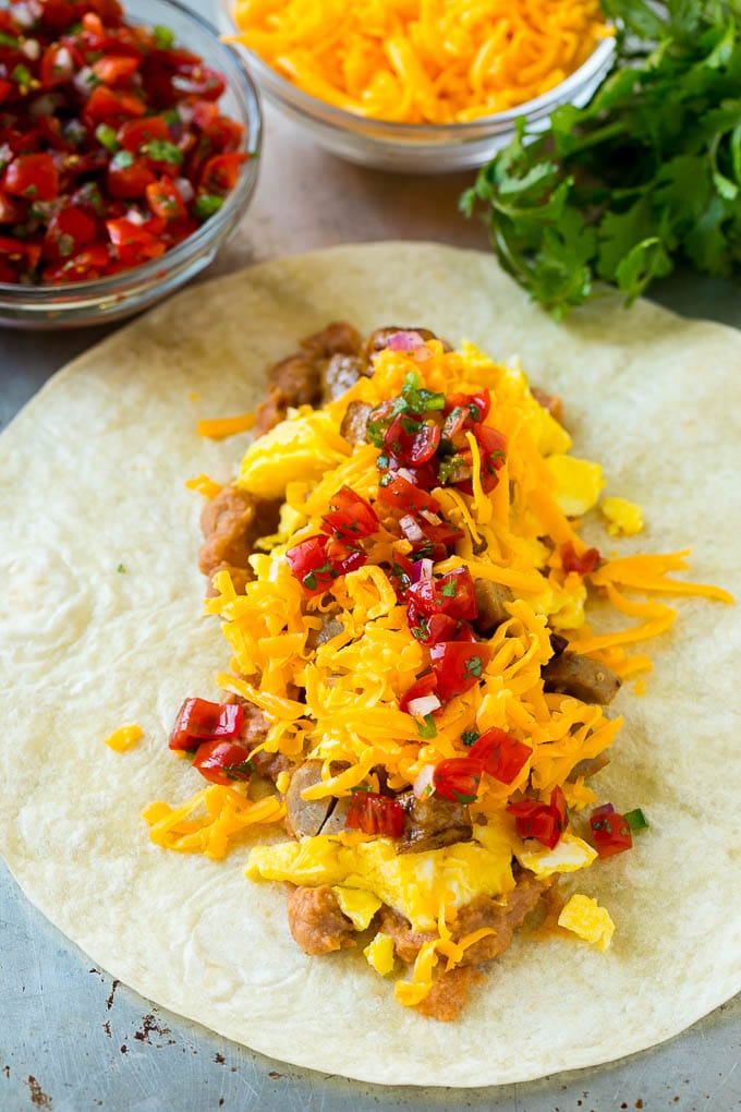 Breakfast Burrito Recipe | Sausage Breakfast Burrito #breakfast #sausage #eggs #burrito #dinneratthezoo A flour tortilla topped with eggs, sausage, cheese and pico de gallo salsa.