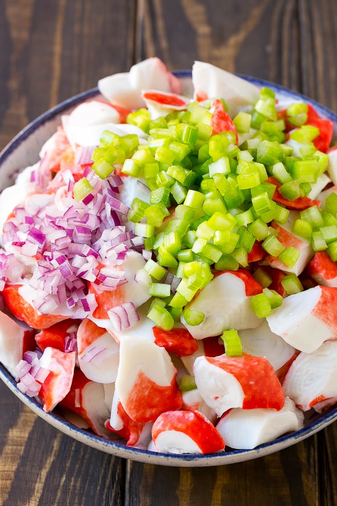 Imitation crab, celery and red onion in a serving bowl.