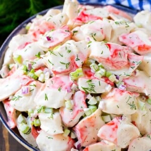 Creamy crab salad with fresh vegetables and dill in a mayonnaise dressing.