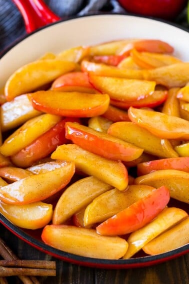 Southern fried apples coated in butter, cinnamon and sugar in a skillet.