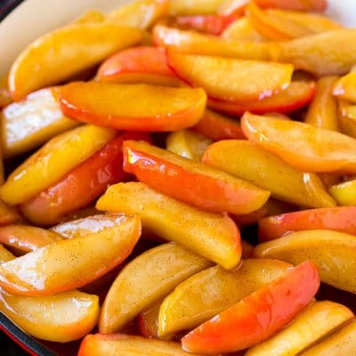 Southern fried apples coated in butter, cinnamon and sugar in a skillet.