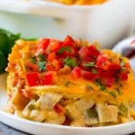 A serving of King Ranch chicken with creamy chicken, tomatoes, vegetables and cheese layered between corn tortillas.