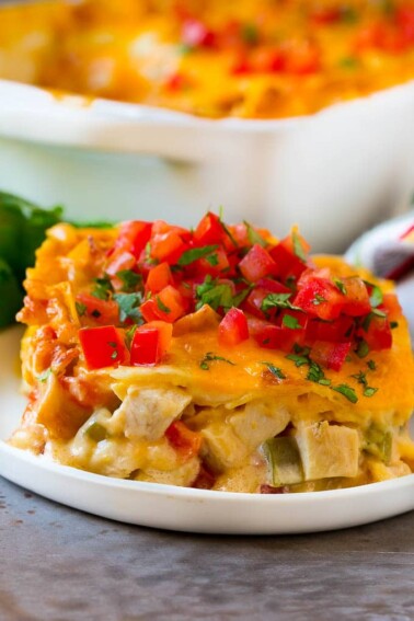 A serving of King Ranch chicken with creamy chicken, tomatoes, vegetables and cheese layered between corn tortillas.