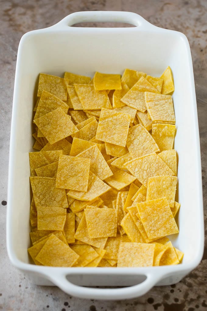 Cut up tortillas in a casserole dish.